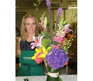 Pictured is Susan Kassen with Ebby Halliday, winner of Floral Design Challenge 2012. Her Charity of choice was National Autism Association of North Texas. Susan Created a floral piece in a leaf wrap vase with Purple Hydrangeas, Lilies, Gerbers and other colorful flowers.
