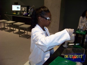 Miss Darby Dugay, a 7th Grader at Lincoln Middle School in Port Arthur, Texas is finding the DNA of a wheat germ at the Ross Perot Museum Downtown Dallas