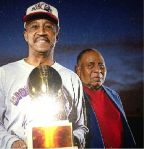 Richard Bonner is shown in a recent photograph with the game trophy with the late Head Coach and former Principal of Hamilton Park School, Mr. James O. Griffin.