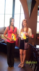 Tyanna Lott and her best friend Payton displaying her mother’s book, Without Fear or Favor  