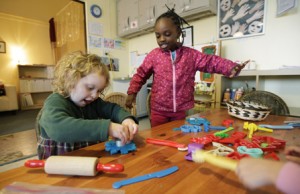 In this April 5, 2012, photo, pre-school students Molly Kiniry, 4, left, and Imani Workcuff, 4, play with play dough at the Refugee and Immigrant Family Center in Seattle. Washington state preschool programs that receive government dollars are among the best in the country but too few kids benefit from the $54 million the state spends on preschool each school year, according to a report released Tuesday, April 10, 2012. (AP Photo/Ted S. Warren)
