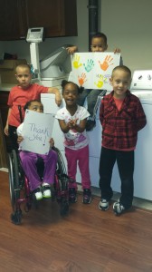 Some of the children at Our Children’s House at Baylor – Irving gather to celebrate the installation of a new energy-efficient washer and dryer donated my business members of the Irving Chamber’s Green Business Council.