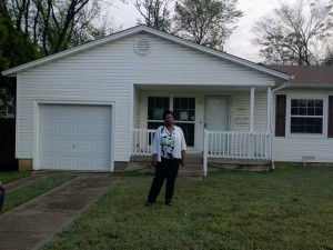 Ella James of Irving, standing in front of house she thought would someday be her home. 