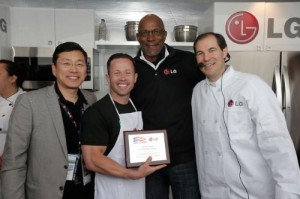 Trey Shearer of Silver Creek Elementary School accepts the award for winning the LG Coaches Cook-Off from William Cho, president and CEO of LG Electronics USA, left, basketball legend Clyde Drexler, back, and Baylor University Head Basketball 