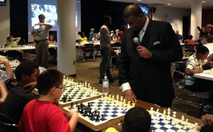 Orrin "Checkmate" Hudson playing a simultaneous game of chess with 59 children at an after-school program in Gadsden, Alabama to teach them pattern recognition.