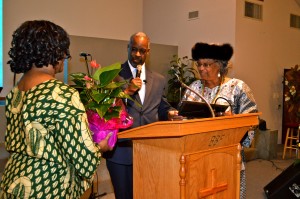 Pastor Brenda Patterson and Pastor Dr. Terrance Woodson present flowers to Sis. Shirley Tarpley at the Black History celebration on Feb. 8, 2015