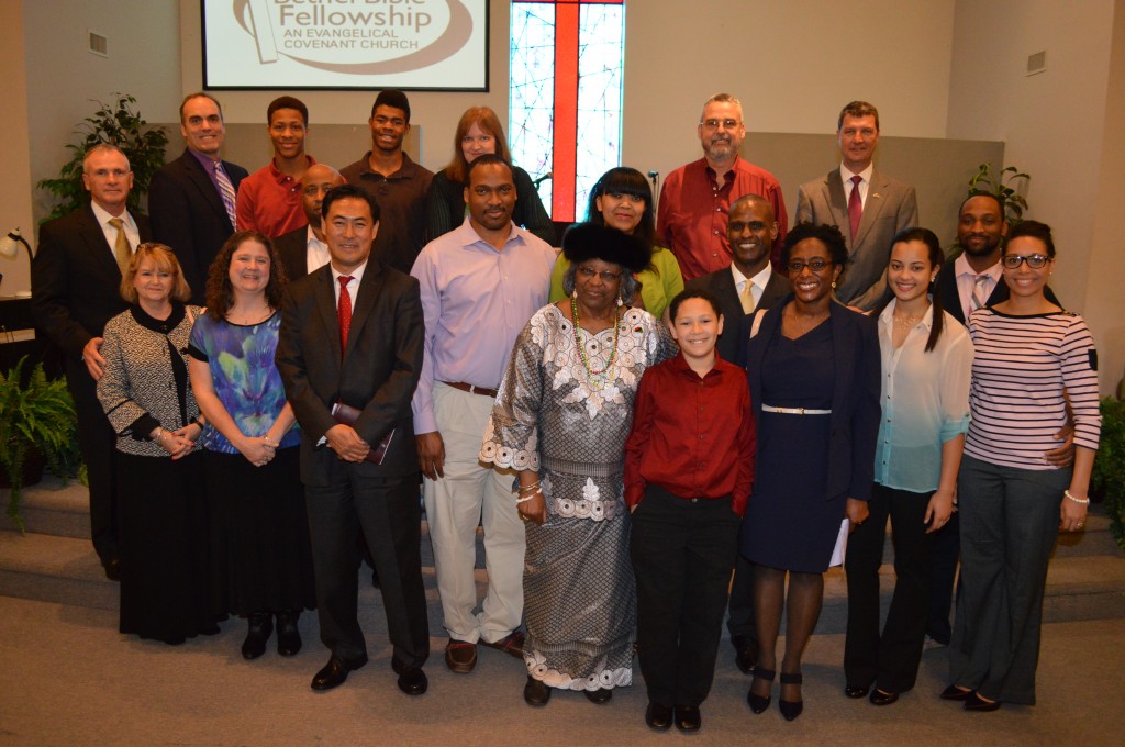 Friends and family, including (back, L to R) Carrollton-Farmers Branch Superintendant Dr. Bobby Burns, Carrollton City Councilmember Steve Babick, Keimone Davis, Zuri Davis, CFB Boardmember Nancy Cline, Carl Goff, Carrollton City Councilmember Doug Hrbacek, (front, L to R) Tina Burns, Peggi Babick, CFB Board Asst. Secretary Richard Fleming, Carrollton City Council candidate Young Sung, Xavier Mottley, Elizabeth Mottley, Jarrell Tarpley, Shelia Tarpley Lott and Tyanna Lott, join (front, center) Sister Shirley Tarpley and youngest grandson Philip Lott in commemorating Tarpley’s contributions to education and the community.