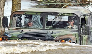 US Army Staff Sgt. William Griffin and Spc. Jessica Sandberg drive a Humvee on a flooded road in Fort Ransom, North Dakota, April 15, 2009. (Credit: US Air Force photo by Senior Master Sgt. David H. Lipp/Released via Expert Infantry/Flickr) 