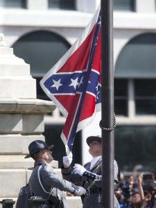 A member of the South Carolina Highway Patrol Honor Guard carries the rolled up Confederate battle flag after it was removed from Statehouse grounds in Columbia, S.C. (Photo: Mykal McEldowney/The Greenville News)
