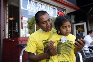 Raul Cruz, from suburban Los Angeles, holds his daughter Sophie Cruz, 5, as the talk to Sophie's mother via telephone, Wednesday, Sept. image:www.krmg.com