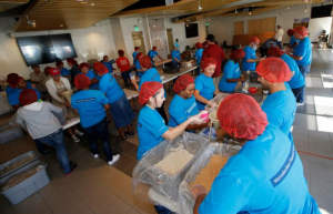 Mercedes-Benz Financial Services in Fort Worth turned a conference room into an assembly line where employees volunteered to pack more than 20,000 servings of food for Kids Against Hunger. Photograph by Ellman Photography. 