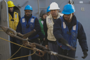 MEDITERRANEAN SEA - Seaman Markievy Hutchins, from Dallas, releases a pelican hook for the sliding pad eye aboard USS Carney (DDG 64) during a replenishment-at-sea with the Military Sealift Command fleet replenishment oiler USNS Leroy Grumman (T-AO 195) Dec. 29, 2015. Carney, an Arleigh Burke-class guided-missile destroyer, forward deployed to Rota, Spain, is conducting a routine patrol in the U.S. 6th Fleet area of operations in support of U.S. national security interests in Europe.   by Mass Communication Specialist 1st Class Theron J. Godbold