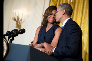 President Barack Obama kisses First Lady Michelle Obama during her remarks at an Affordable Care Act reception in the East Room of the White House, May 1, 2014. (Official White House Photo by Pete Souza)