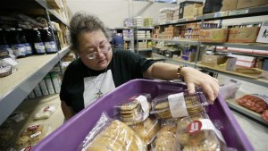 A volunteer unloads donated baked goods at a food bank in Des Moines, Iowa. Food banks could become strained, as more than 500,000 people could lose food stamps in 22 states reinstating work requirements this winte
