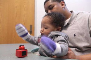 Three-month-old infants were outfitted with Velcro mittens to teach them early reaching skills. (Credit: Vanderbilt)