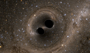 The collision of two black holes is seen in this still from a computer simulation. The simulation shows what the merger would look like if we could somehow get a closer look. Time has been slowed by a factor of 100. The stars appear warped due to the strong gravity of the black holes. (Credit: SXS)