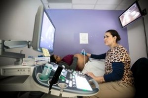 EnlargePhoto by Michael Stravato Under a sign warning about Zika virus, Josseline Lopez, 22, gets an ultrasound from technician Ivonne Murillo at Legacy Community Health Clinic in Houston on Feb. 25, 2016.