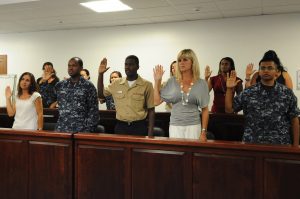 Candidates for U.S. citizenship recite the oath of citizenship during a naturalization ceremony at Naval Air Station Sigonella. (U.S. Navy photo by Mass Communication Specialist 1st Class Erica R. Gardner/Released)