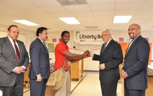 Liberty Bank and Trust CEO Alden McDonald cuts the ribbon at Liberty Bank Sci Academy Senior Science Lab in New Orleans. Photo: Liberty Bank Facebook page 