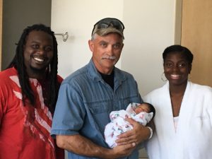 Senior Corporal Munster holds little Ms. Jaliah Wade with proud parents Mr. & Mrs. Wade