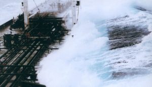 A 60-foot rogue wave hits the OVERSEAS CHICAGO tanker as it heads south from Valdez, Alaska in 1993. The ship was running in 25-foot seas when the monster wave hit it on the starboard side. (Credit: Captain Roger Wilson courtesy of NOAA)