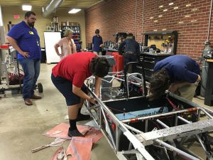 Winston students work on their car.