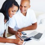 Young couple calculating monthly expenses